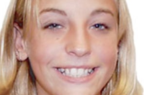 Young person smiling brightly, displaying teeth after orthodontic treatment, closeup portrait.