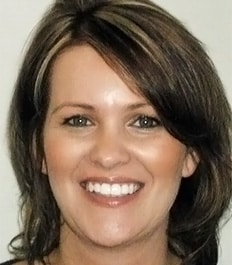 Woman smiling at camera in professional headshot for orthodontics practice